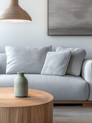 Minimalist living room interiors with a sofa, a couch and a large window bathing the room with day light.