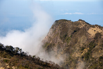 cliff on a mountain with a blue sky background