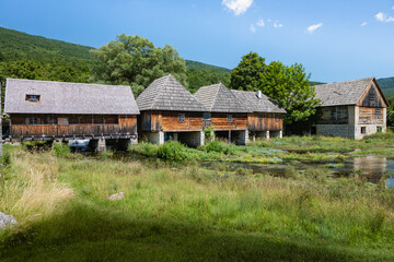 Obraz premium Majerovo Vrilo, beautiful wooden mill houses on the spring of Gacka river, Croatia, one of the last mills preserved in this mountain region