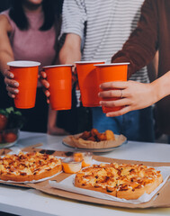 Group of young friends eating pizza.Home party.