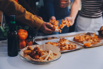 Group of young friends eating pizza.Home party.