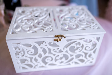 Elegant white decorative box with intricate cut-out design. A beautifully crafted white decorative...