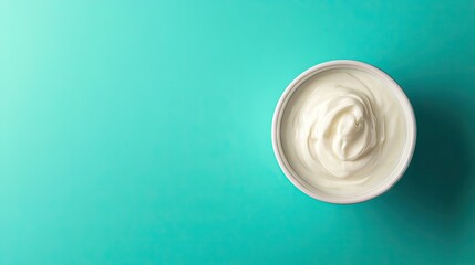 A white bowl of yogurt isolated on a vibrant solid background, leaving space for text in the upper portion of the image.