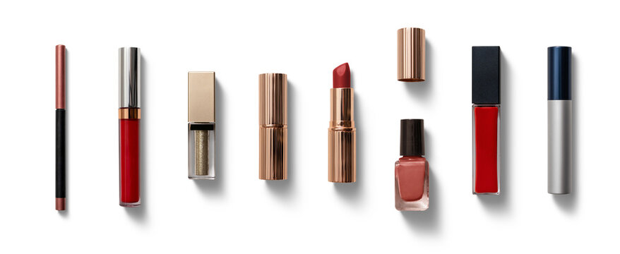 Various cosmetics including lipsticks, glosses, and nail polish are elegantly arranged on a white background, showcasing vibrant colors and textures