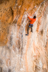 A rock climber ascends to the summit via a difficult route.