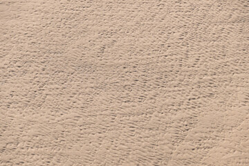 Footprints on a sandbank. Sandy background.