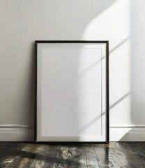 Minimalist framed artwork against a white wall in a sunlit room with wooden floors.