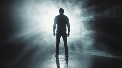 Dramatic man silhouette  artistic image of figure standing in bright light with striking shadow