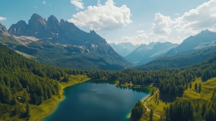 Fototapeta premium Aerial view of Lago Antorno in the Dolomites, showcasing the serene lake surrounded by majestic Alps peaks and lush greenery, offering a breathtaking mountain landscape.