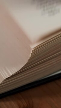Slow motion of flicking through old book pages.