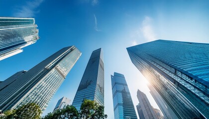 Panoramic view of skyscrapers against a bright blue sky. The city skyline shows tall buildings and modern architecture.