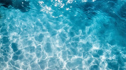 Obraz premium Crystal-clear blue water with gentle ripples in a pool, reflecting summer sunlight