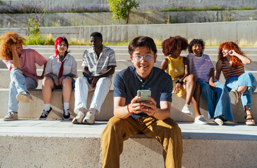 Multiethnic group of young friends meeting and having fun outdoors - Multiracial happy and stylish teen students bonding in the city, concepts about youth, teenagers lifestyle and diversity