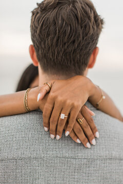 Woman wrapping her hands around her partners neck