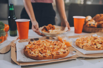 Group of young friends eating pizza.Home party.
