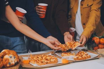 Group of young friends eating pizza.Home party.