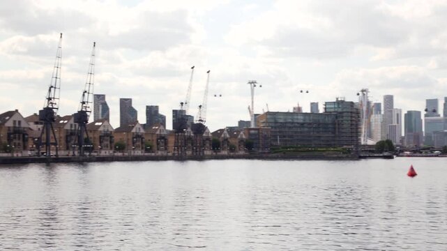 Waterfront dockland housing along Royal Docks. London, UK, 28 July 2024