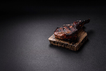 Juicy grilled beef tomahawk steak with salt, spices and herbs