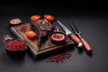 Juicy grilled beef tomahawk steak with salt, spices and herbs