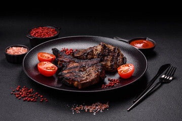 Juicy grilled beef tomahawk steak with salt, spices and herbs