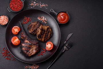 Juicy grilled beef tomahawk steak with salt, spices and herbs