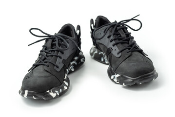 Black leather shoes isolated on white background. A pair of modern stylish black sneakers.