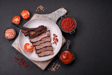 Juicy grilled beef tomahawk steak with salt, spices and herbs