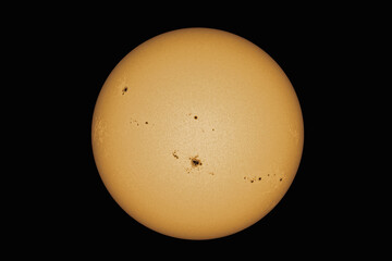 A view of our sun with sunspots through a telescope.