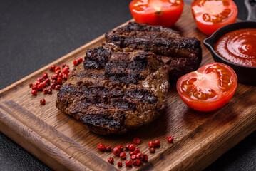 Fresh juicy delicious beef steak on a dark background