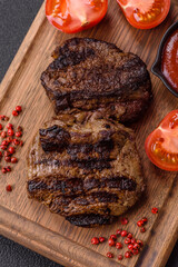 Fresh juicy delicious beef steak on a dark background