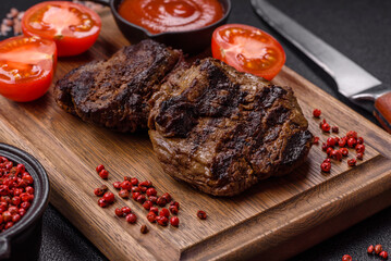 Fresh juicy delicious beef steak on a dark background