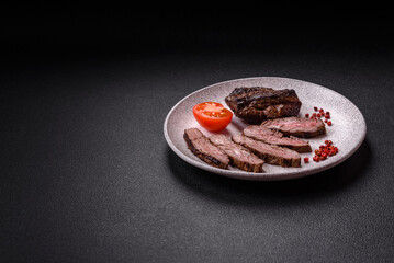 Fresh juicy delicious beef steak on a dark background
