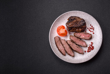 Fresh juicy delicious beef steak on a dark background