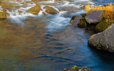 River creek cascade. River flow in nature. Natural stream of river rock. Water of river flow in wilderness. Wilderness nature brook. Stream of creek water. Nature wildness