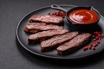 Fresh juicy delicious beef steak on a dark background