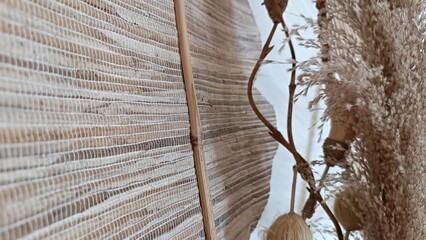 Close-Up of Woven Bamboo Screen and Natural Branches