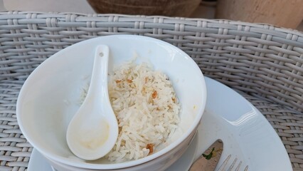 Simple Rice Bowl with Spoon on Woven Tray