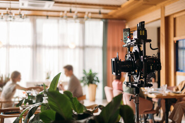 Professional film and video camera on the set. Shooting shift, equipment and group.