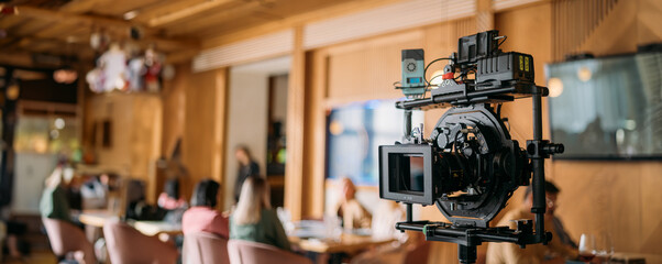 Professional film and video camera on the set. Shooting shift, equipment and group.