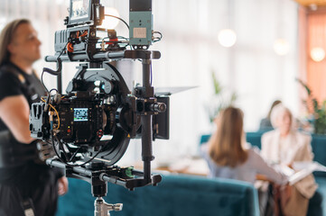 Professional film and video camera on the set. Shooting shift, equipment and group.