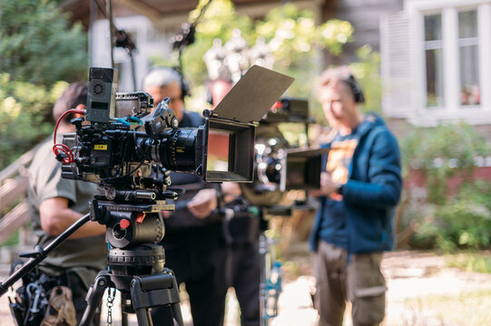 Professional film and video camera on the set. Shooting shift, equipment and group.