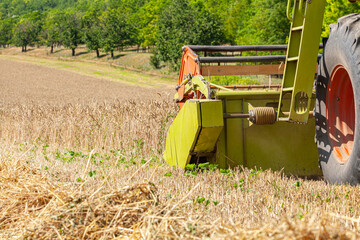 The combine harvester collects the crops at harvest time. Harvester working in the field.