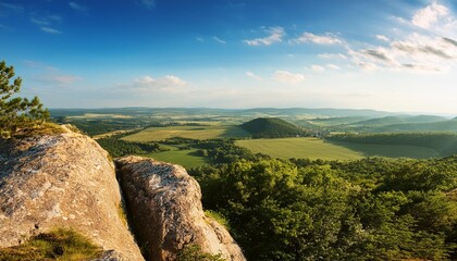 Fototapeta premium A view of the countryside from the top of a rock