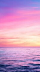 Soft pastel sunset over the calm ocean, with gentle hues of pink, purple, and blue blending in the sky. The tranquil scene captures the serene beauty of nature. © kanoktuch