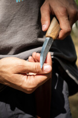 hands of a person and a knife