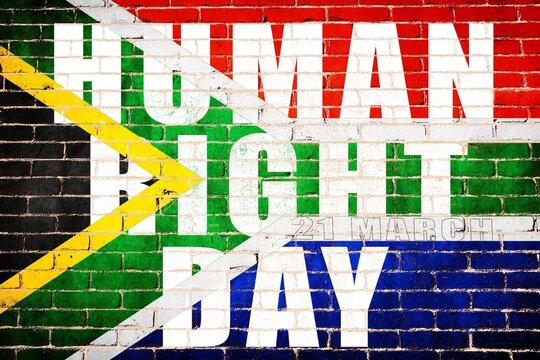 The national Human right day text on the flag of South Africa depicting in paint colors on an old brick wall. Flag banner on brick wall background