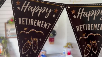camera slides over a happy retirement party string decoration