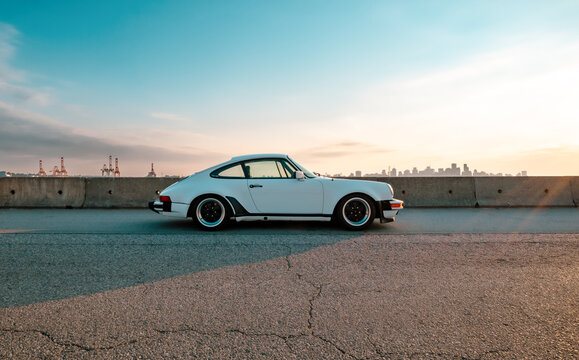 Porsche 911 SC Classic parked on street on sunset. Vintage sportscar with wide body. Produced in Germany from 1978 to 1983. Selective focus. Vancouver, BC, Canada, Sept 2023