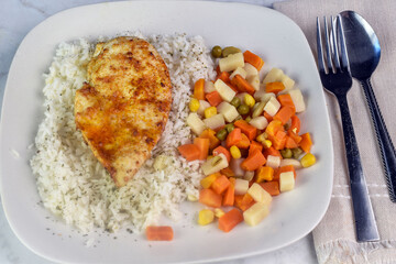 seasoned chicken breast  on rice top with seasoning
