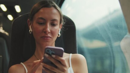 Young woman with headphones use phone in train - Powered by Adobe